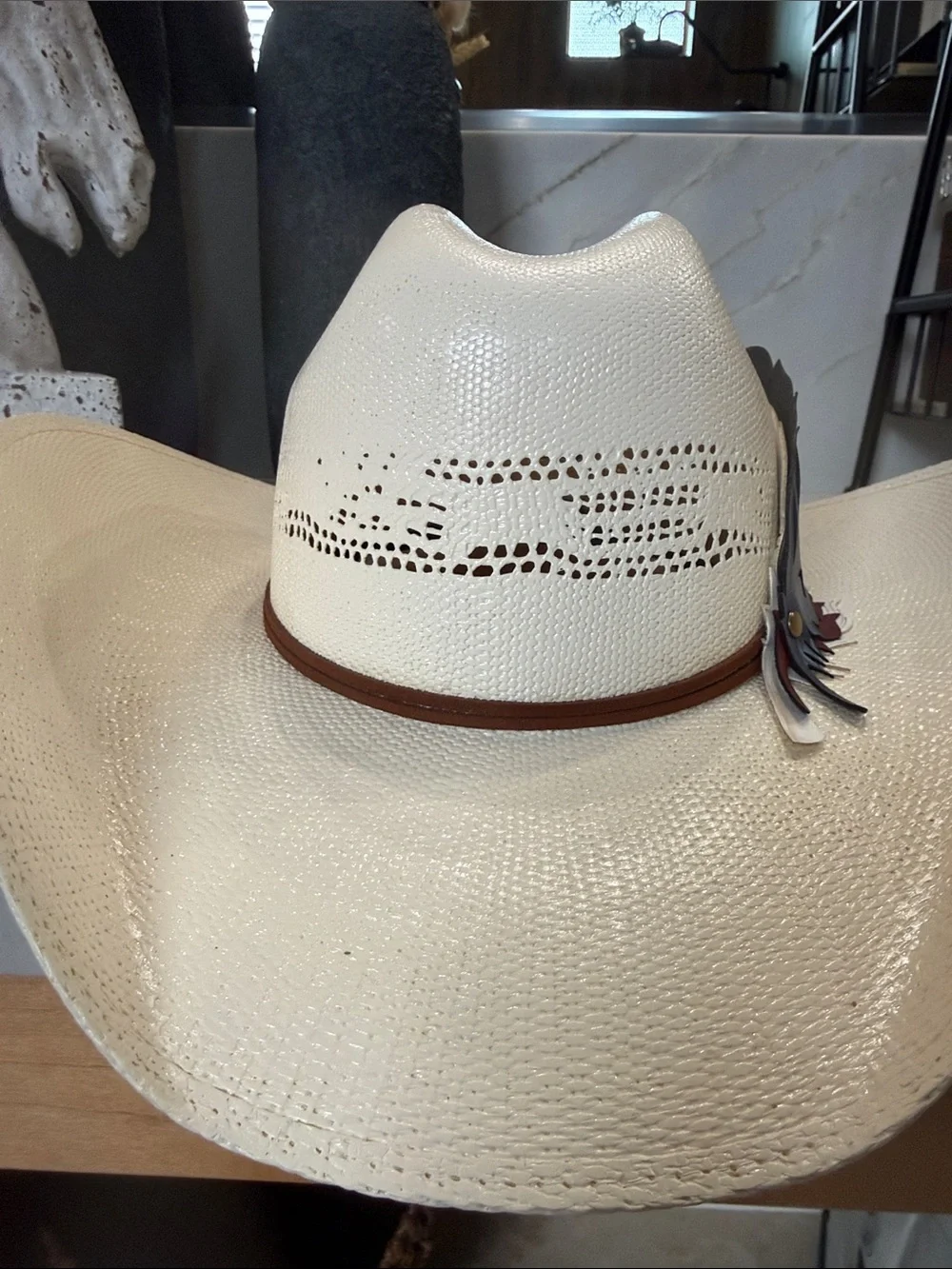 White Straw Cowboy Hat with Patriotic Red White and Blue Feathers.